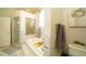 Bathroom featuring a large soaking tub, glass enclosed shower, and a linen closet at 8760 Plantation Ridge Blvd, Lakeland, FL 33809