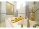 This is a bathroom with a large soaking tub and glass enclosed shower, both with tile surround at 8760 Plantation Ridge Blvd, Lakeland, FL 33809