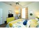 Comfortable bedroom showcasing hardwood floors, a colorful bedspread, and natural light from a large window at 8760 Plantation Ridge Blvd, Lakeland, FL 33809