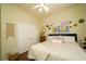 Comfortable bedroom with a queen size bed, lots of natural light, and a decorative painting above the bed at 8760 Plantation Ridge Blvd, Lakeland, FL 33809