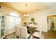 Bright dining room with modern chandelier, wood floors and lots of natural light at 8760 Plantation Ridge Blvd, Lakeland, FL 33809
