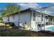 Back of the house featuring a screened-in pool, utility access and antenna at 8760 Plantation Ridge Blvd, Lakeland, FL 33809