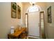 Bright foyer with a decorative table, arched window above the front door, and neutral decor at 8760 Plantation Ridge Blvd, Lakeland, FL 33809