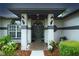 Inviting front entrance with well-lit porch, decorative columns, and charming landscaping at 8760 Plantation Ridge Blvd, Lakeland, FL 33809