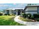 Inviting home exterior showcasing a manicured lawn, walkway, and well-maintained landscaping at 8760 Plantation Ridge Blvd, Lakeland, FL 33809