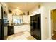 Well-maintained kitchen features white cabinetry, black appliances, and a bright, airy atmosphere at 8760 Plantation Ridge Blvd, Lakeland, FL 33809