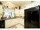 Charming kitchen with white cabinets, modern appliances, and a window overlooking the backyard at 8760 Plantation Ridge Blvd, Lakeland, FL 33809
