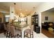 Bright kitchen with island seating, white cabinets, and modern appliances flows into adjacent living area at 8760 Plantation Ridge Blvd, Lakeland, FL 33809
