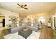 Bright living room with a large sofa and open layout to dining area, perfect for gatherings at 8760 Plantation Ridge Blvd, Lakeland, FL 33809