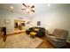 Cozy living room showcases hardwood floors, comfortable seating, and an open layout to the adjacent kitchen at 8760 Plantation Ridge Blvd, Lakeland, FL 33809