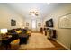 Inviting living room features a plush sofa, decorative pillows, and large screen television for entertainment at 8760 Plantation Ridge Blvd, Lakeland, FL 33809