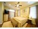 The main bedroom has neutral walls, hardwood floors, ceiling fan, and double doors to outside at 8760 Plantation Ridge Blvd, Lakeland, FL 33809
