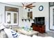 Beautiful covered patio with comfortable seating, TV, ceiling fan, and tasteful nautical decor at 8760 Plantation Ridge Blvd, Lakeland, FL 33809