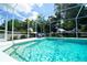 Refreshing pool featuring a screened enclosure, lounge chairs, and easy access to the home at 8760 Plantation Ridge Blvd, Lakeland, FL 33809