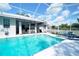 Inviting screened-in pool with lounge chairs and covered seating, perfect for relaxation and entertaining at 8760 Plantation Ridge Blvd, Lakeland, FL 33809