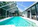 Inviting pool with screened enclosure, lounge chairs, and a partial view of the home's exterior at 8760 Plantation Ridge Blvd, Lakeland, FL 33809