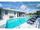 Inviting pool featuring a screened enclosure, lounge chairs, and easy access to the home at 8760 Plantation Ridge Blvd, Lakeland, FL 33809