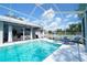 Inviting screened-in pool with lounge chairs, perfect for relaxation and entertaining at 8760 Plantation Ridge Blvd, Lakeland, FL 33809