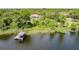 Waterfront property with a private dock and lush surroundings, offering serene lakeside living at 9093 S Bay Dr, Haines City, FL 33844