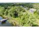 Secluded waterfront property featuring a private dock amidst a lush, green landscape at 9093 S Bay Dr, Haines City, FL 33844