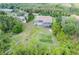 Expansive backyard featuring a screened-in pool, lush greenery, and serene surroundings at 9093 S Bay Dr, Haines City, FL 33844