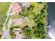 Overhead view of a home and lake with private dock and extensive grounds, offering space and privacy at 9093 S Bay Dr, Haines City, FL 33844