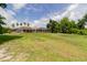 Expansive backyard featuring a screened lanai and lush greenery, perfect for outdoor enjoyment at 9093 S Bay Dr, Haines City, FL 33844