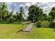 Wooden bridge spanning a grassy area surrounded by trees and natural landscaping at 9093 S Bay Dr, Haines City, FL 33844