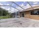 Screened-in patio and in-ground pool with views of the expansive backyard and lush landscaping at 9093 S Bay Dr, Haines City, FL 33844