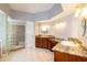 Spacious bathroom featuring dual sinks, a glass block shower, and ample counter space at 9093 S Bay Dr, Haines City, FL 33844