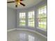 Bedroom features bright windows, neutral paint, and tile flooring at 9093 S Bay Dr, Haines City, FL 33844