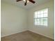 Bedroom featuring neutral walls, a ceiling fan, and a bright window at 9093 S Bay Dr, Haines City, FL 33844