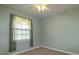 Bedroom featuring light-green walls, a ceiling fan, and a bright window at 9093 S Bay Dr, Haines City, FL 33844