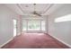 Spacious bedroom featuring a tray ceiling, large windows, and a sliding glass door at 9093 S Bay Dr, Haines City, FL 33844