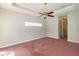 Bright bedroom with tray ceilings, fan and high horizontal window at 9093 S Bay Dr, Haines City, FL 33844