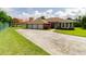 Charming single-story home with a three-car garage and well-manicured lawn at 9093 S Bay Dr, Haines City, FL 33844