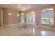 Bright foyer boasts tile flooring, decorative molding, and elegant chandelier lighting at 9093 S Bay Dr, Haines City, FL 33844