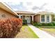 Inviting home entrance with a tidy walkway framed by colorful landscaping and a classic white front door at 9093 S Bay Dr, Haines City, FL 33844