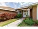 Charming home entrance with well-manicured landscaping and a welcoming walkway leading to the front door at 9093 S Bay Dr, Haines City, FL 33844