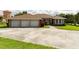 Charming home with a three-car garage, and a inviting walkway leading to the front door at 9093 S Bay Dr, Haines City, FL 33844