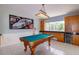 Spacious game room featuring a billiard table and custom cabinetry, ideal for entertainment at 9093 S Bay Dr, Haines City, FL 33844