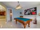 Entertaining game room, features a billiard table, custom artwork and easy access to a half-bathroom at 9093 S Bay Dr, Haines City, FL 33844