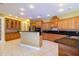 Bright kitchen with wood cabinets, granite countertops, stainless steel appliances, and tile flooring at 9093 S Bay Dr, Haines City, FL 33844
