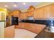 Spacious kitchen featuring wooden cabinets, stainless steel appliances, and elegant granite countertops at 9093 S Bay Dr, Haines City, FL 33844