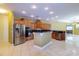 Spacious kitchen features wood cabinets, stainless steel appliances, and a center island at 9093 S Bay Dr, Haines City, FL 33844