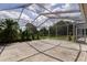 Screened lanai with concrete flooring providing ample space for outdoor activities at 9093 S Bay Dr, Haines City, FL 33844