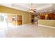 Open-concept living area with sliding glass doors and kitchen access at 9093 S Bay Dr, Haines City, FL 33844