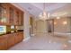 Elegant living space featuring tile flooring, chandeliers and a convenient wet bar at 9093 S Bay Dr, Haines City, FL 33844
