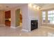Bright living room featuring fireplace and view to kitchen and outside at 9093 S Bay Dr, Haines City, FL 33844
