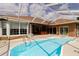 Beautiful pool with a screened-in enclosure and bar area, perfect for entertaining guests at 9093 S Bay Dr, Haines City, FL 33844